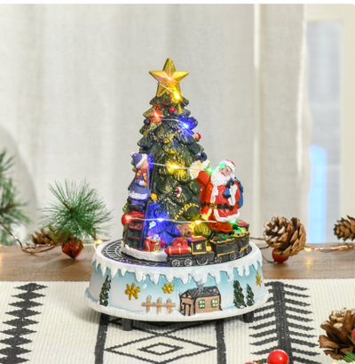 Decorative Christmas tree with Santa Claus and lights on a spinning base.